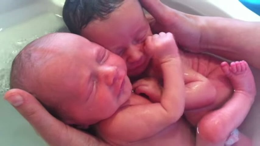 Newborn twins won’t stop cuddling like they did in the womb