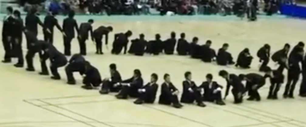 40 men stood in formation, and their complicated routine is leaving everyone in awe