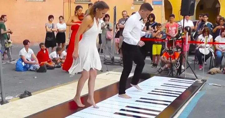 Couple Mesmerizes Crowd Playing Giant Piano With Their Feet!